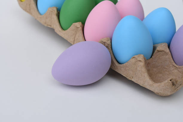 istock Purple easter egg with dyed eggs in carton 1136450474