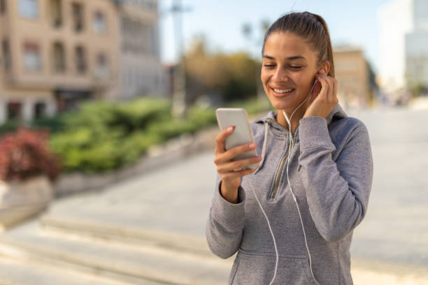 istock Girl texting on smartphone in the city 1136452002