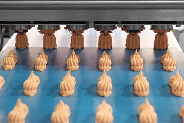 cooking many sweet meringue on blue production line. sweet food concept. - automatically imagens e fotografias de stock