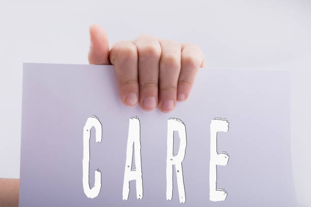 istock Hand holding paper with care wording 1136457777