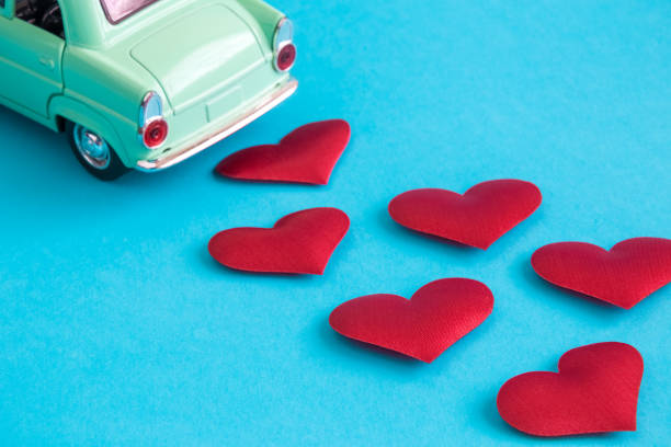 Miniature car with hearts minimal just married creative concept.
