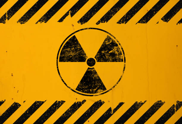 istock Black radioactive sign over yellow background 1136460576