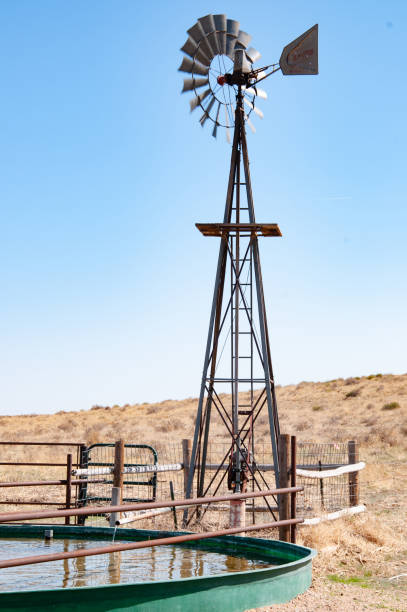 istock Windmill and water tank for livestock 1136461397