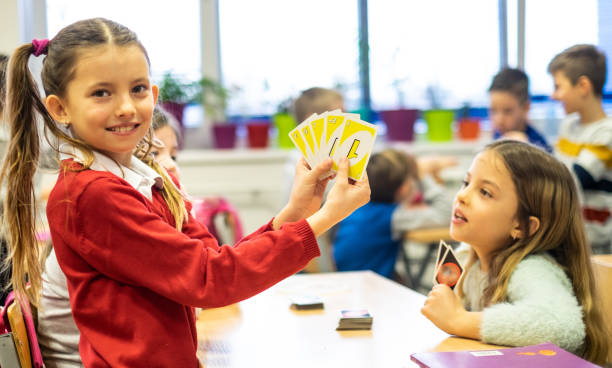 Girls play cards at school