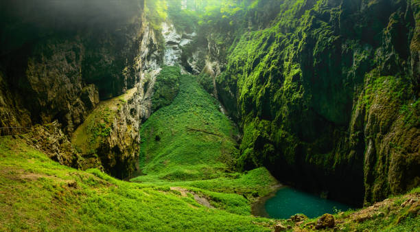 istock Macocha Abyss, Moravian Karst microclimate with juicy greenery and a small lake. 1136466341