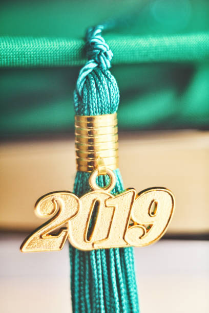 Green mortarboard with 2019 Graduation tassel and books