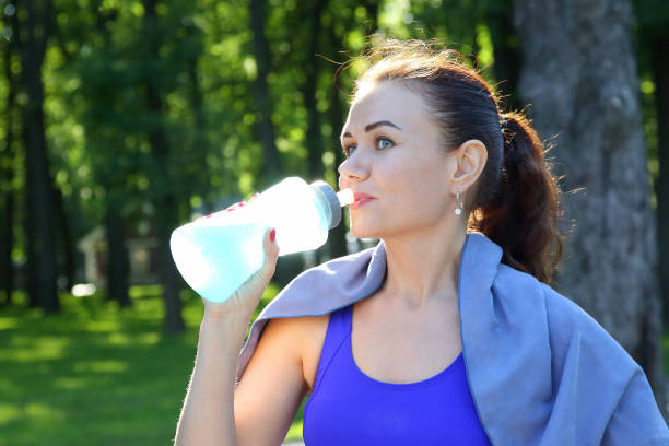 istock young sporty girl drinking water from a bottle 1136474937