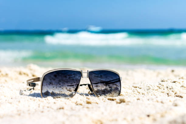 istock Close up sunglasses on tropical beach and white sandy background. Summer vacation concept. traveling and relax. 1136476866