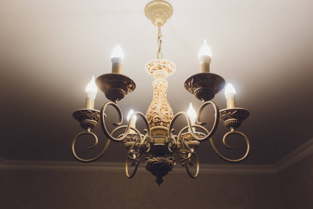 istock Chandelier on ceiling with classic design decorations and lights on in six lamps. 1136477737