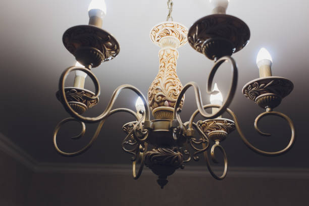 istock Chandelier on ceiling with classic design decorations and lights on in six lamps. 1136477743