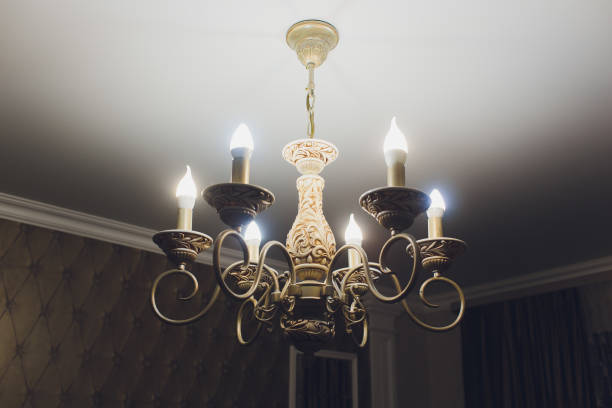 istock Chandelier on ceiling with classic design decorations and lights on in six lamps. 1136477746