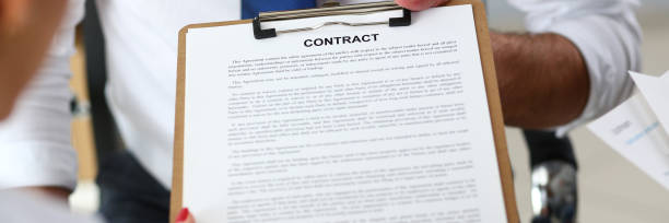 istock Male arm offer contract form on clipboard pad 1136477863