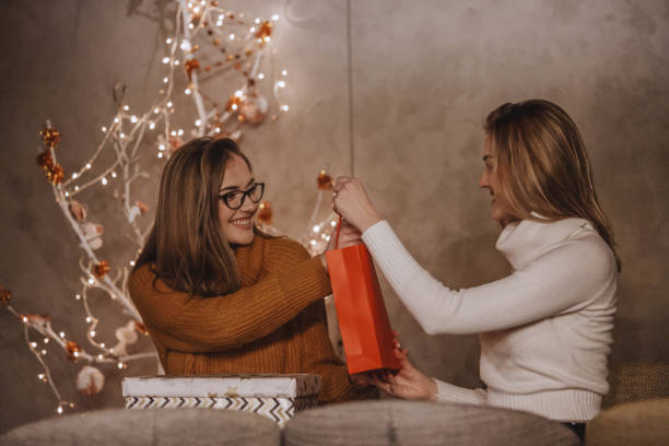 istock Loving sisters exchanging Christmas gifts 1136478000