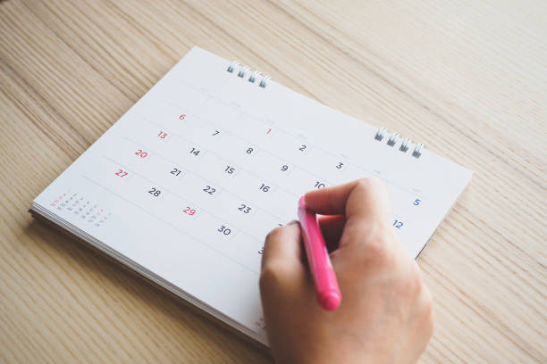 istock Hand with pen writing on calendar page closeup 1136478054