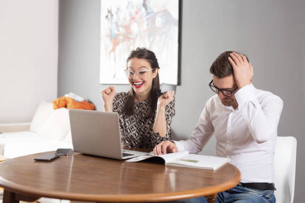 istock Young married couple sitting at table in apartment 1136487066