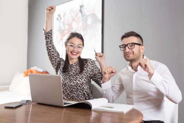 istock Young happy married couple sitting at table in apartment 1136487751