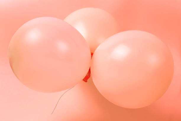 istock Three Balloons on a coral background close-up, holiday concept 1136493834