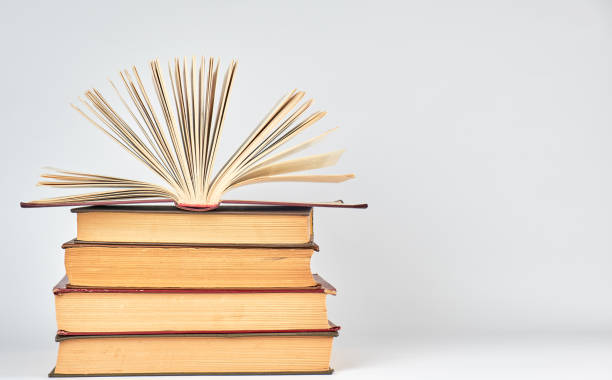 istock stack of books and an open book with yellow pages 1136494517