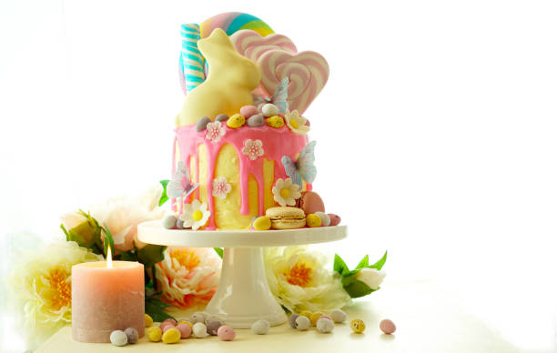 istock Easter candy land drip cake decorated with lollipops and white bunny. 1136497656