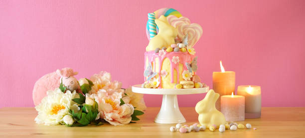 istock Easter candy land drip cake decorated with lollipops and white bunny. 1136497784
