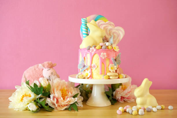 istock Easter candy land drip cake decorated with lollipops and white bunny. 1136497834
