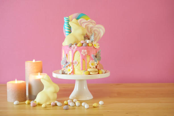 istock Easter candy land drip cake decorated with lollipops and white bunny. 1136497887