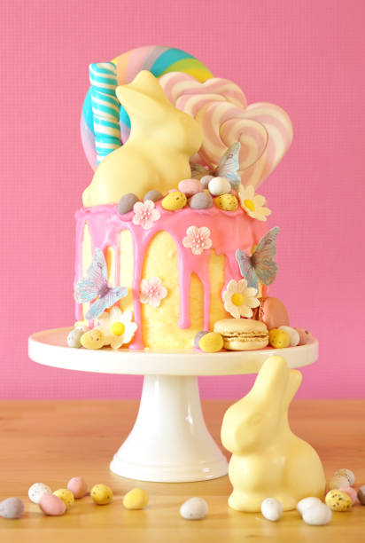 istock Easter candy land drip cake decorated with lollipops and white bunny. 1136497946