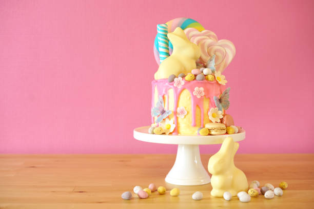 istock Easter candy land drip cake decorated with lollipops and white bunny. 1136498012