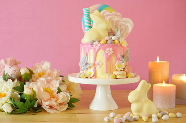 istock Easter candy land drip cake decorated with lollipops and white bunny. 1136498132