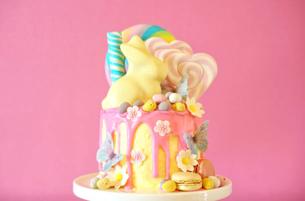 istock Easter candy land drip cake decorated with lollipops and white bunny. 1136498191