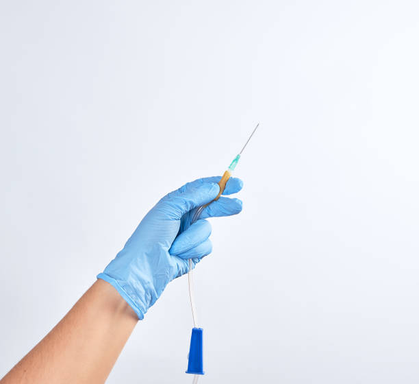 istock hand in blue sterile glove holds plastic dropper system 1136499716