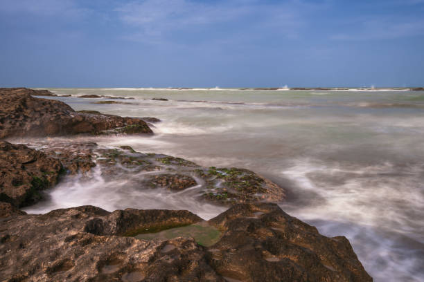 istock Colorful sea shore with green algae, long exposure water 1136502745