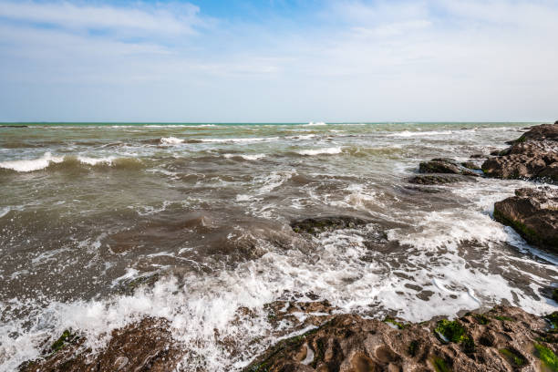 istock Splash of waves on a rocky seashore 1136502833