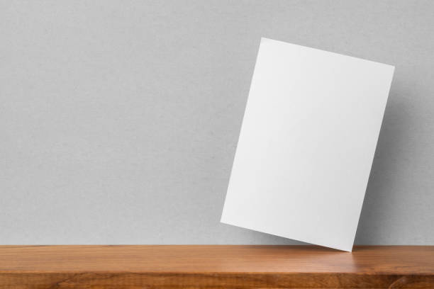 istock front view of A4 paper on bookshelf and grey wall 1136507619