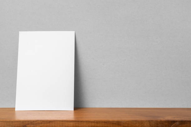 istock front view of A4 paper on bookshelf and grey wall 1136507631