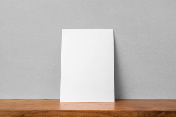 istock front view of A4 paper on bookshelf and grey wall 1136507643