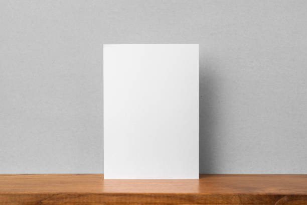 istock front view of A4 paper on bookshelf and grey wall 1136507654