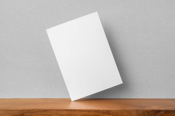 istock front view of A4 paper on bookshelf and grey wall 1136507659