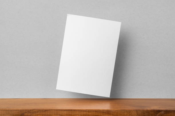 istock front view of A4 paper on bookshelf and grey wall 1136507670