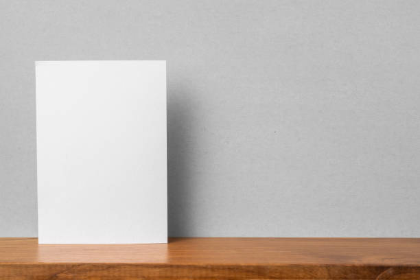 istock front view of A4 paper on bookshelf and grey wall 1136507680