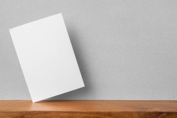 istock front view of A4 paper on bookshelf and grey wall 1136507683