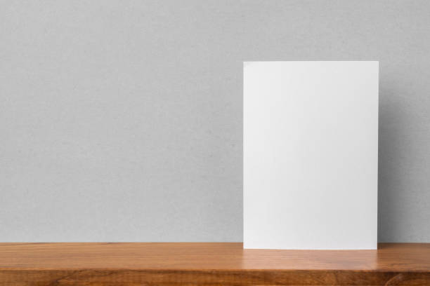 istock front view of A4 paper on bookshelf and grey wall 1136507689