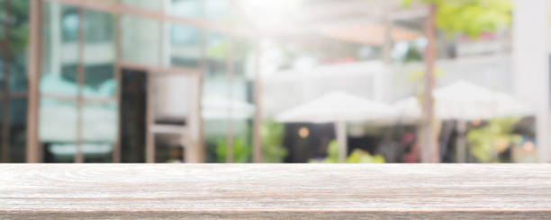 istock Empty wood table top and blurred restaurant exterior banner background - can used for display or montage your products. 1136507841