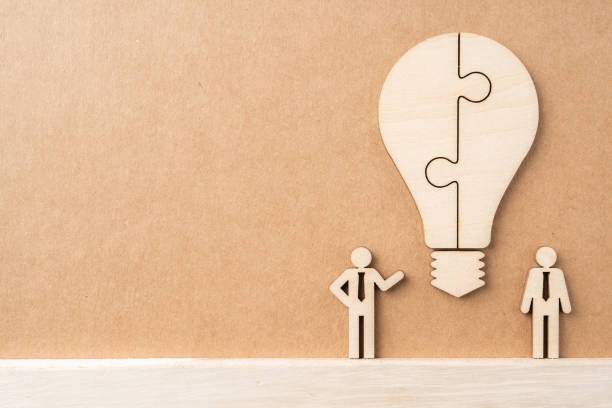 istock wooden businessman and light bulb, idea concept 1136508455