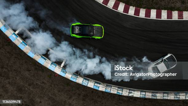 Two Cars Drifting Battle On Race Track With Smoke Aerial View Two Car Drifting Battle Stock Photo - Download Image Now