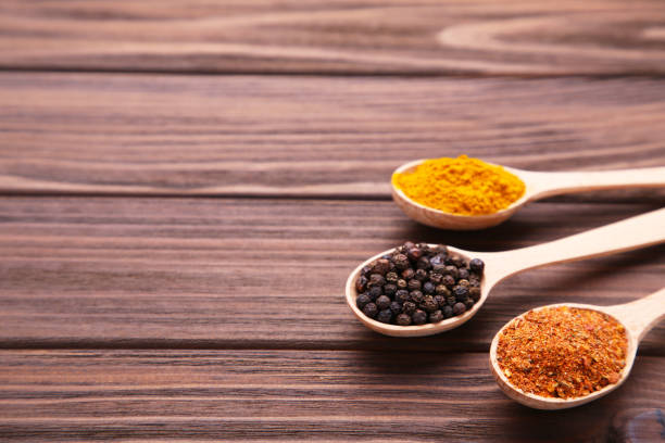 istock Spices mix in spoon on a brown wooden background. Top view 1136509588