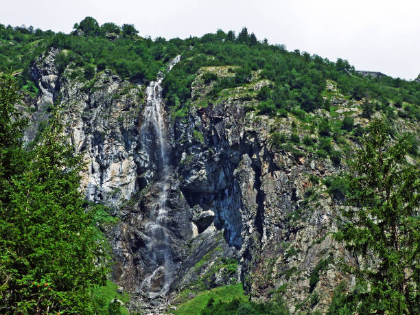 istock Waterfall Sidensackfall or Wasserfall Sidensackfall, Spritzbach stream in the Alpine Valley of Maderanertal 1136513449