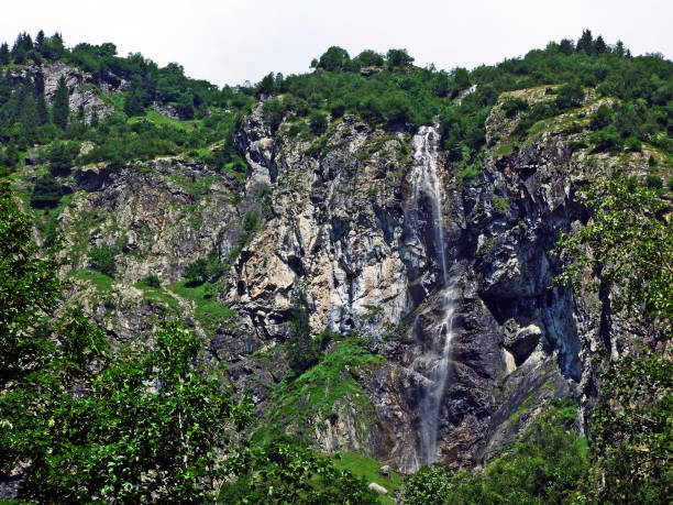istock Waterfall Sidensackfall or Wasserfall Sidensackfall, Spritzbach stream in the Alpine Valley of Maderanertal 1136513456