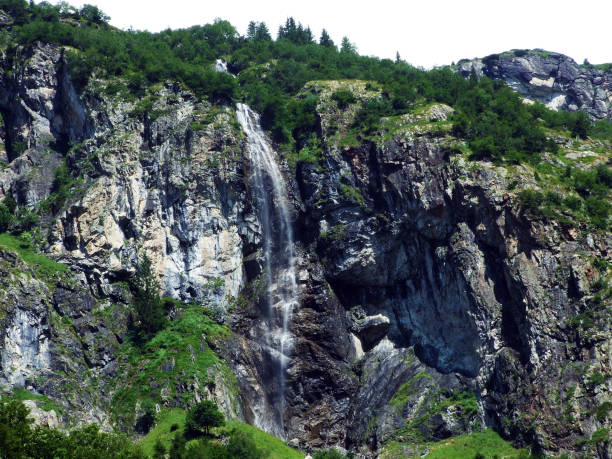 istock Waterfall Sidensackfall or Wasserfall Sidensackfall, Spritzbach stream in the Alpine Valley of Maderanertal 1136513458