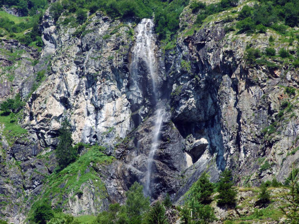 istock Waterfall Sidensackfall or Wasserfall Sidensackfall, Spritzbach stream in the Alpine Valley of Maderanertal 1136513471